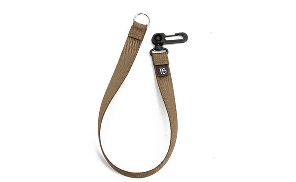 A 16-inch Coyote (tan) Key Strap with a snaphook at one end and a split-ring o-ring at the other.
